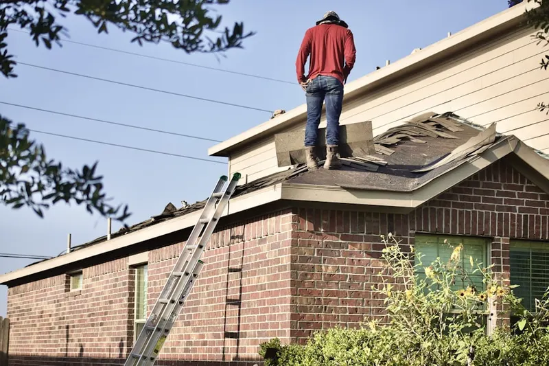 Professional roofer working on a residential roof in Davenport